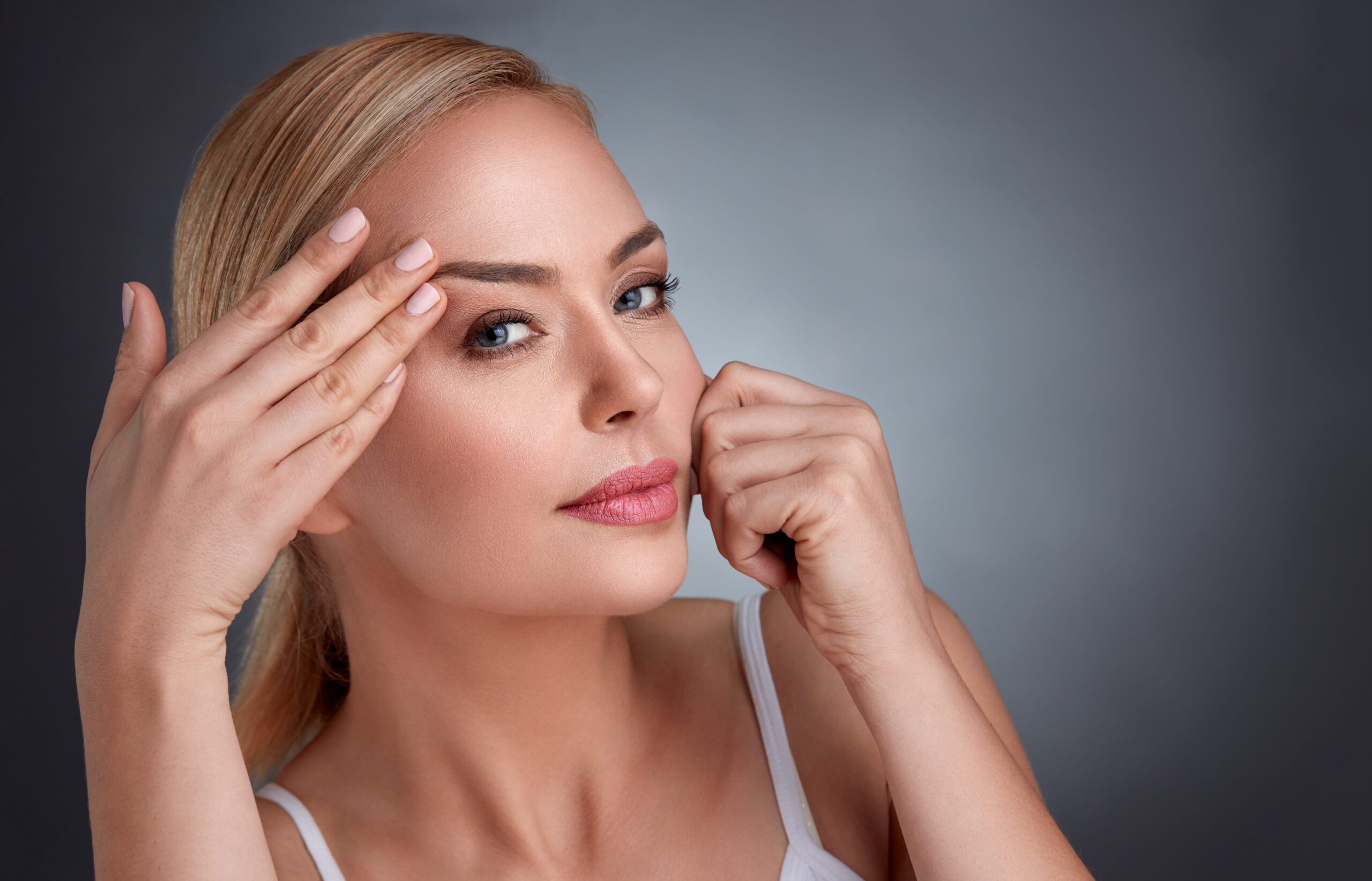 beautiful woman in the struggle with traces of aging, wrinkles